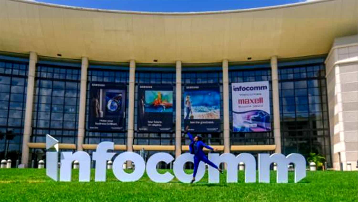 Innovative tech conference center with glass facade and large promotional banners.