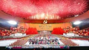 Colorful grand celebration with fireworks and large gathering at a Chinese cultural event in a stadium.