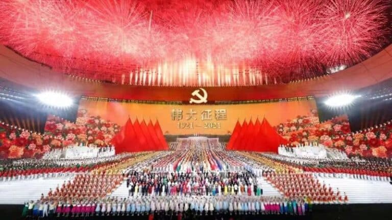 Colorful grand celebration with fireworks and large gathering at a Chinese cultural event in a stadium.