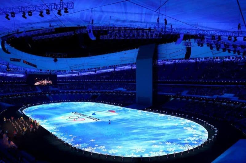 Cosmiconn at Ice Skating Arena, illuminated for a winter sports event, showcasing vibrant blue lighting and ice skating activities.