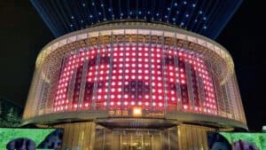 Cosmiconn event venue illuminated with dynamic LED display at night.