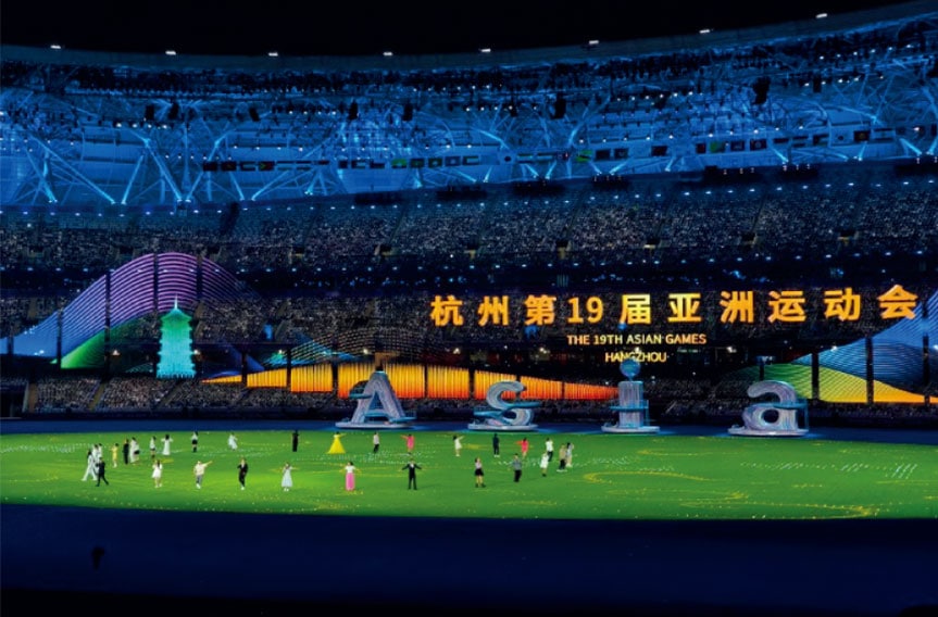 Colorful stadium during the 19th Asian Games in Hangzhou with vibrant lights and cultural displays.